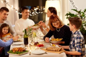 celebration, holidays and people concept - happy family having dinner party at home