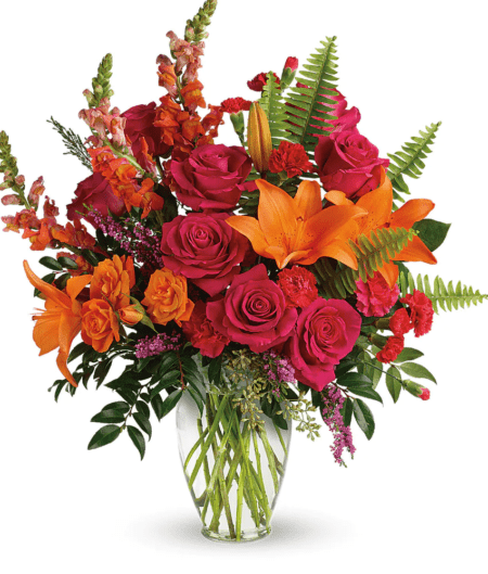 The bright stuff for punching up anyone's mood! Bring happiness to any day with this bold, sunset-inspired blend of hot pink roses and orange lilies in a classic glass vase!